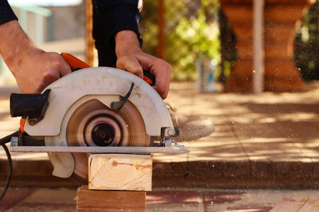 A man saws boards with a circular saw